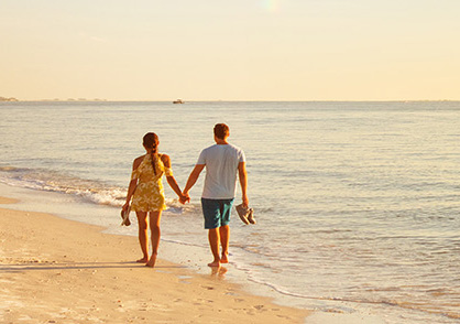 healthy couple walking on the beach